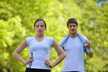 Image showing Couple doing stretching exercise  after jogging