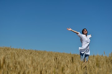 Image showing young woman in wheat field at summer