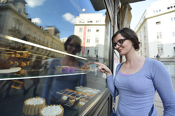 Image showing woman in front of sweet store window