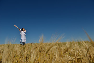 Image showing young woman in wheat field at summer