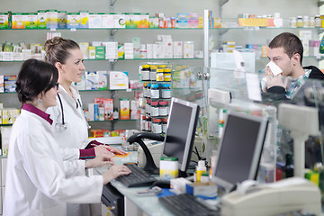 Image showing pharmacist suggesting medical drug to buyer in pharmacy drugstor