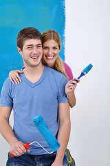 Image showing happy couple paint wall at new home