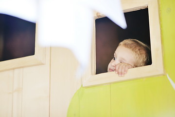 Image showing happy child in a window