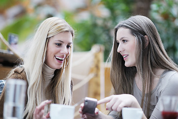 Image showing cute smiling women drinking a coffee