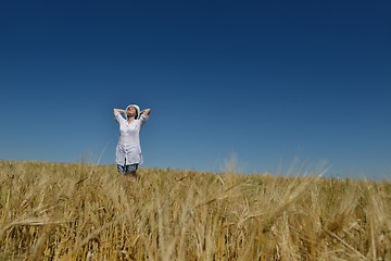 Image showing young woman in wheat field at summer