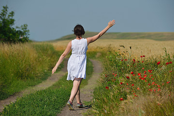 Image showing young woman in wheat field at summer