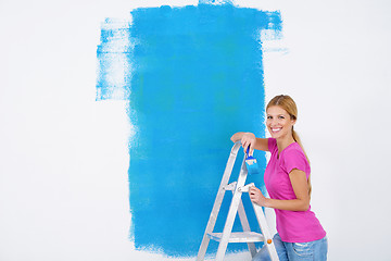 Image showing happy smiling woman painting interior of house