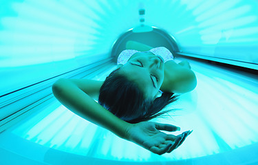 Image showing Beautiful young woman tanning in solarium