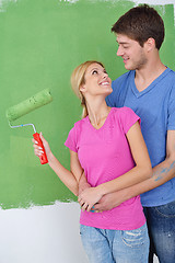 Image showing happy couple paint wall at new home