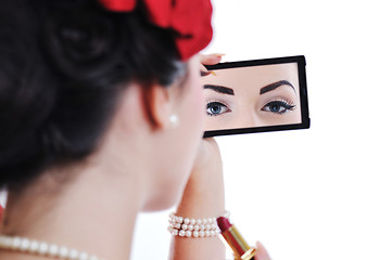 Image showing beautiful young woman applying makeup