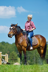 Image showing happy woman  ride  horse