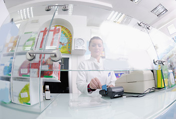 Image showing pharmacist suggesting medical drug to buyer in pharmacy drugstor