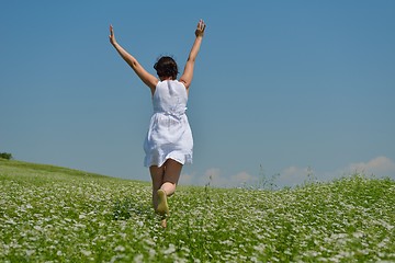 Image showing Young happy woman in green field