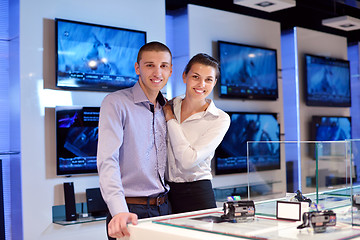 Image showing Young couple in consumer electronics store