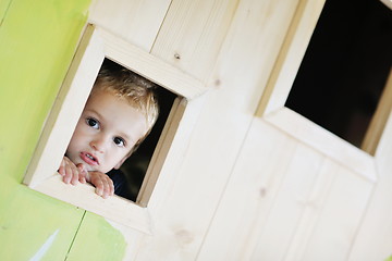 Image showing happy child in a window