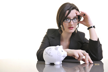 Image showing business woman putting money coins in piggy bank