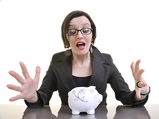 Image showing business woman putting money coins in piggy bank