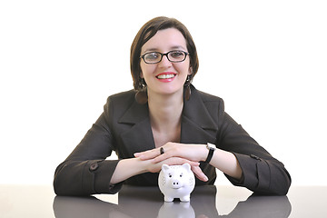 Image showing business woman putting money coins in piggy bank