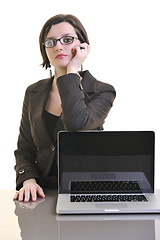 Image showing business woman working on laptop isolated on white