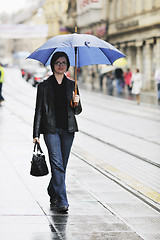 Image showing woman on street with umbrella