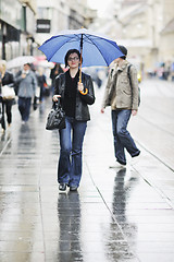 Image showing woman on street with umbrella