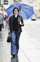 Image showing woman on street with umbrella