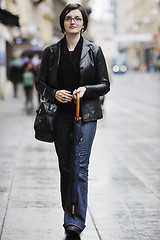 Image showing woman on street with umbrella