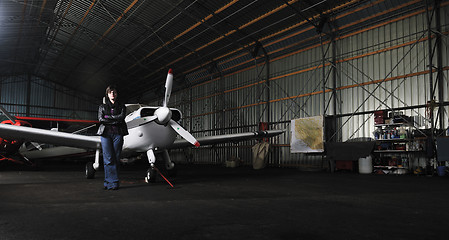 Image showing young woman with private airplane