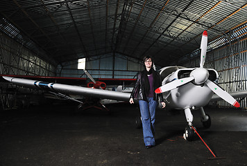 Image showing young woman with private airplane