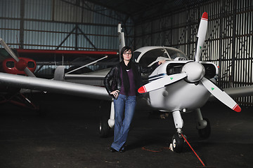 Image showing young woman with private airplane