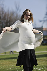 Image showing happy young pregnant woman outdoor