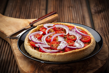 Image showing Homemade onion quiche with tomatoes