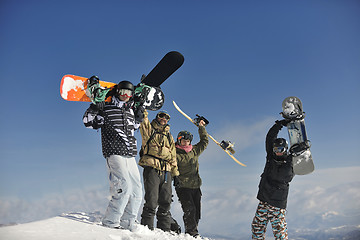 Image showing snowboarders group relaxing and enjoy sun