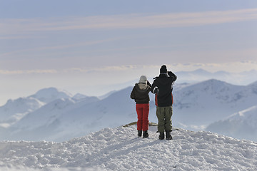 Image showing snowboarder's couple on mountain's top