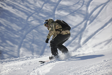 Image showing freestyle snowboarder jump and ride