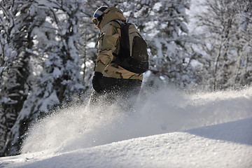 Image showing freestyle snowboarder jump and ride