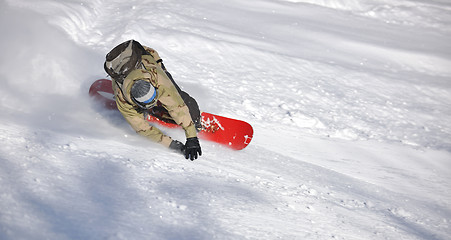 Image showing freestyle snowboarder jump and ride