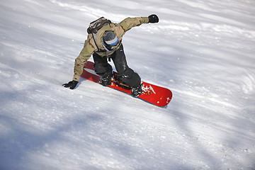 Image showing freestyle snowboarder jump and ride