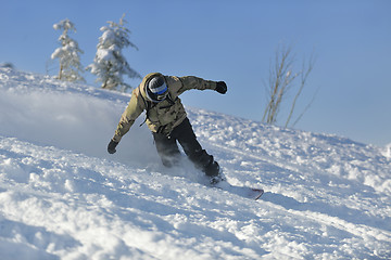 Image showing freestyle snowboarder jump and ride