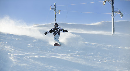 Image showing freestyle snowboarder jump and ride