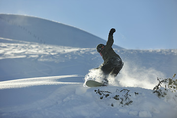 Image showing freestyle snowboarder jump and ride