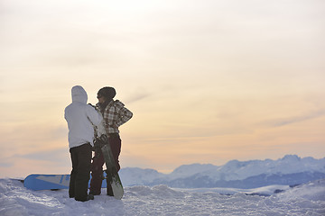 Image showing snowboarder's couple on mountain's top