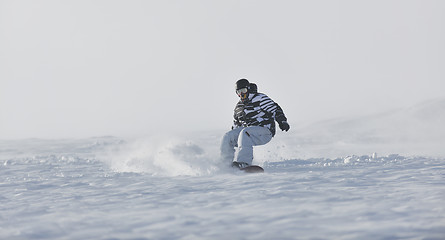 Image showing freestyle snowboarder jump and ride