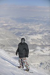 Image showing freestyle snowboarder jump and ride