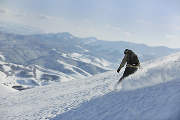 Image showing freestyle snowboarder jump and ride