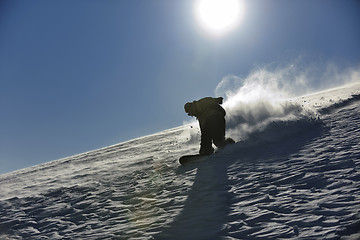 Image showing freestyle snowboarder jump and ride