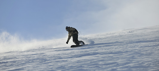 Image showing freestyle snowboarder jump and ride