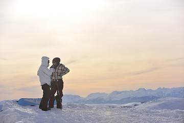 Image showing snowboarder's couple on mountain's top