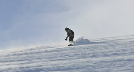 Image showing freestyle snowboarder jump and ride