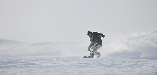 Image showing freestyle snowboarder jump and ride